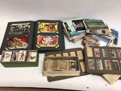 Lot 245 - Box of postcards and cigarette cards, some in albums and some loose, some damp affected
