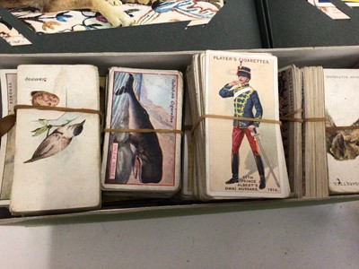 Lot 245 - Box of postcards and cigarette cards, some in albums and some loose, some damp affected
