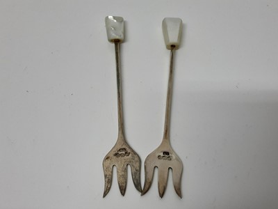 Lot 767 - Two silver and mother of pearl pickle forks and a selection of cased flatware