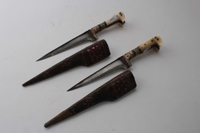 Lot 858 - Old Gurkha Kukri in leather covered sheath, together with two Persian Kabz daggers and two other Eastern daggers (5)