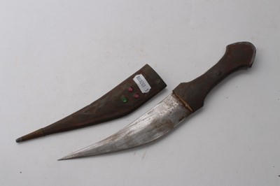 Lot 858 - Old Gurkha Kukri in leather covered sheath, together with two Persian Kabz daggers and two other Eastern daggers (5)