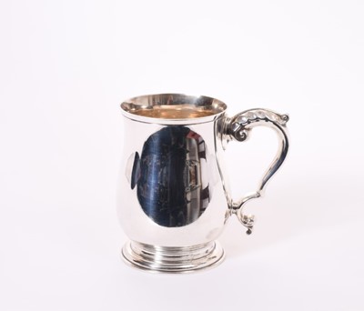 Lot 358 - Elizabeth II Georgian style silver mug of baluster form, with leaf mounted scroll handle, on a circular base (Birmingham 1960), maker J.B. Chatterley & Sons Ltd