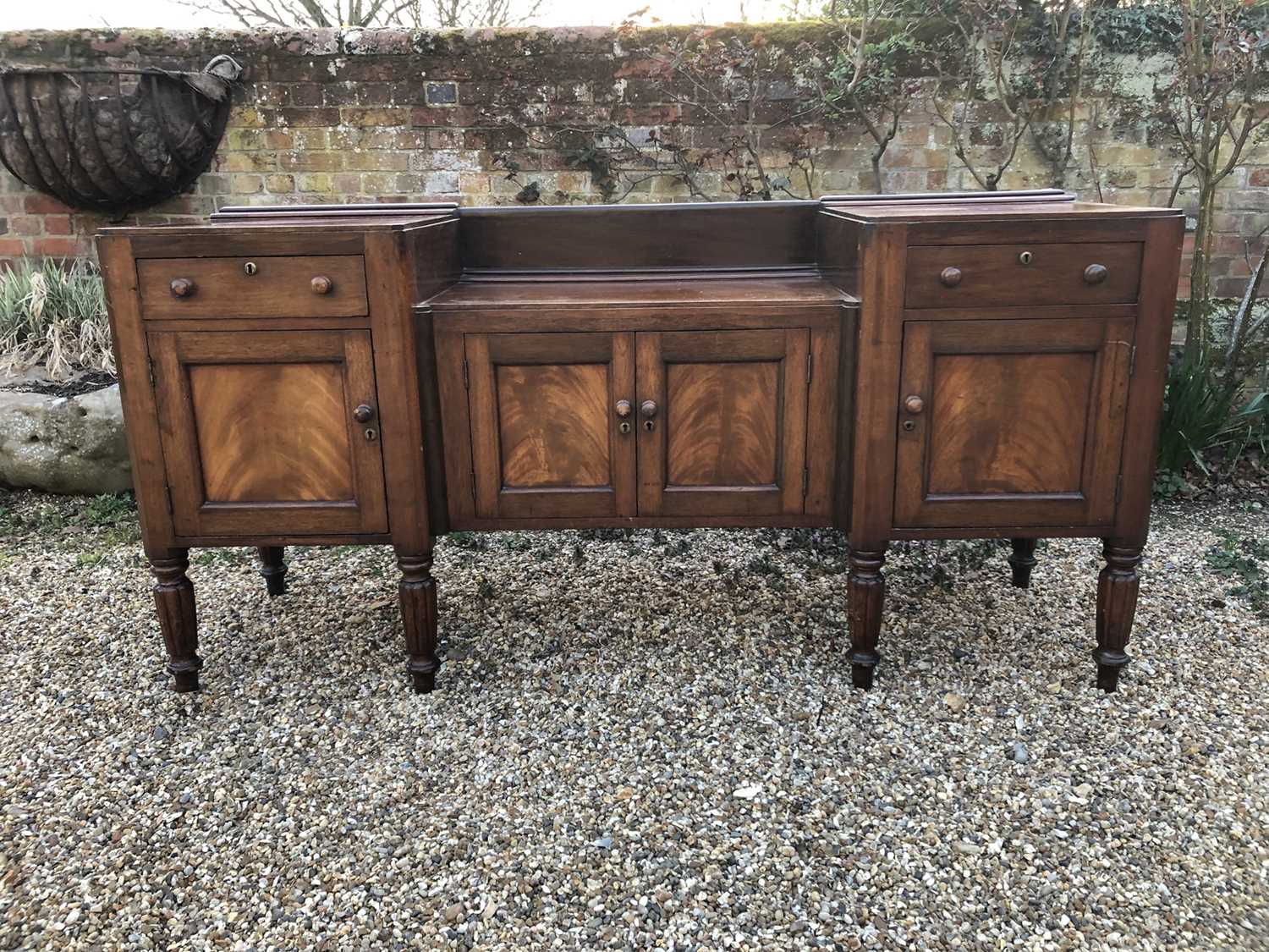 Lot 106 - William IV mahogany sideboard with sunk centre and an arrangement of two drawers and four cupboards, on turned and fluted tapered legs, 192cm wide x 60cm deep x 94cm high