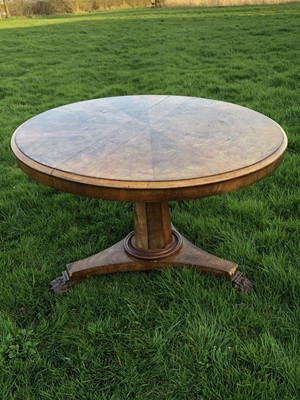 Lot 28 - Victorian walnut dining table with circular tilt top, on hexagonal tapered column and plateau base with carved lion paw feet, 121cm diameter x 75cm high