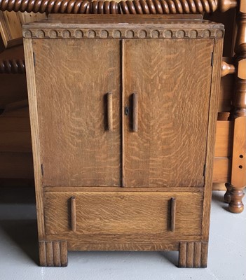 Lot 24 - 1920's oak cabinet with two panelled doors and single drawer below