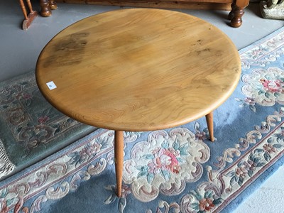 Lot 25 - Ercol 'Golden Dawn' circular coffee table together with two Chinese rugs