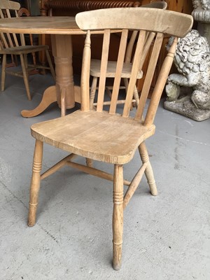 Lot 66 - Beech drop leaf kitchen table together with a set of four pine stick back chairs