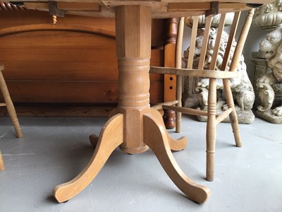 Lot 66 - Beech drop leaf kitchen table together with a set of four pine stick back chairs