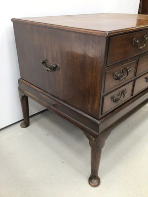 Lot 36 - Georgian mahogany chest on stand with an arrangement of drawers, the top long drawer enclosing pigeon holes and small drawers above six short drawers with brass swan neck handles, on associated sta...