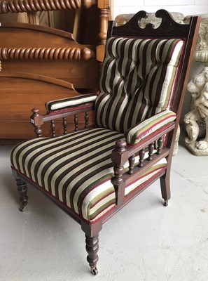 Lot 68 - Late Victorian carved mahogany armchair with striped button upholstery on turned front feet H106, W68, D75cm