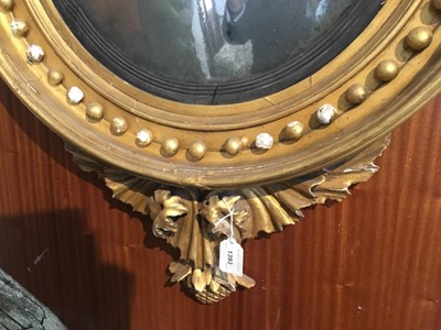 Lot 1393 - Regency gilt framed convex wall mirror with eagle surmount