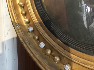 Lot 1393 - Regency gilt framed convex wall mirror with eagle surmount