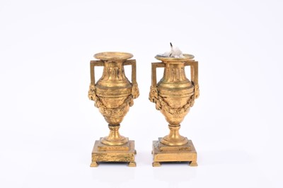 Lot 800 - Pair 19th century ormolu candlesticks of urn form each with twin lions head handles and swags on square stepped soles 15 cm high