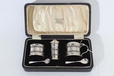 Lot 306 - George V silver three piece cruet set of drum form with pierced Greek key decoration and removable blue glass liners (Birmingham 1925 / 1926), maker Docker & Burn Ltd, together with associated silv...