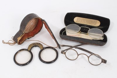 Lot 802 - Pair George IV silver spectacles with extending arms, HM London 1825, pair old Chinese folding spectacles in case and pair vintage spectacles in case (3)