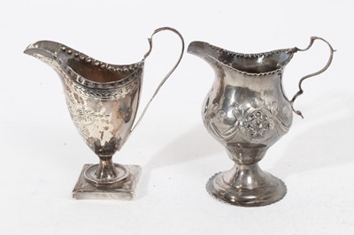 Lot 324 - George III silver milk / cream jug of helmet form with brite cut engraved decoration, raised on a square pedestal foot, (London 1792), together with another George III silver milk / cream jug of ba...