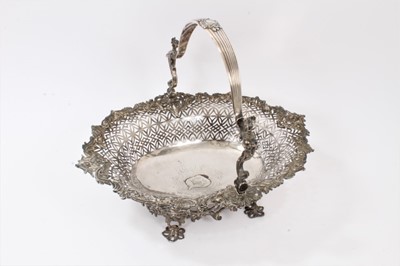 Lot 440 - Fine George II silver cake basket of shaped oval, with pierced decoration and engraved armorial to centre, the swing handle with mermaid-form supports and reeded decoration