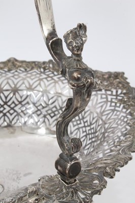 Lot 440 - Fine George II silver cake basket of shaped oval, with pierced decoration and engraved armorial to centre, the swing handle with mermaid-form supports and reeded decoration
