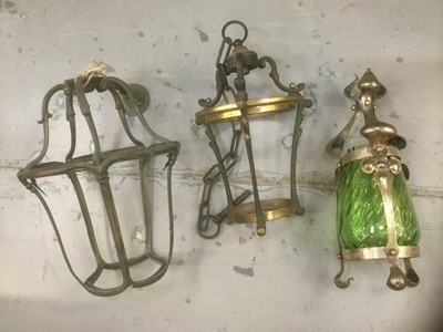 Lot 381 - Arts and Crafts metal lamp with green glass shade together with two lantern frames in brass (3)