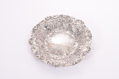 Lot 326 - Victorian silver bread dish with ornate embossed floral and scroll decoration, (London 1885), maker John Angell II & George Angel, all at approximately 9oz, 24cm in diameter