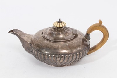 Lot 329 - George IV silver teapot of squat form with fluted decoration, domed hinged cover with ivory finial and fruitwood handle, on circular foot (London 1827), maker Rebecca Emes & Edward Barnard I, all a...