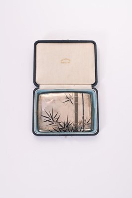 Lot 331 - 20th Century Japanese silver cigarette case of curved rectangular form with niello work decoration of bamboo trees, stamped silver 950 to interior, in fitted box by Samurai Shokai, Yokohama, all at...