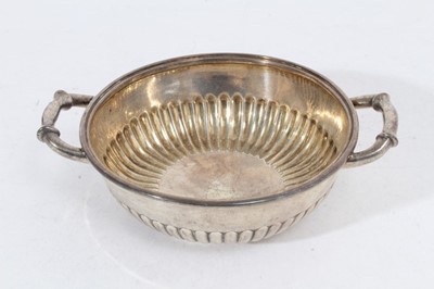 Lot 335 - George III silver two handled bowl of shallow circular form with fluted decoration, on circular foot, (London 1804), maker John Emes, all at approximately 10oz, 16.5cm in diameter