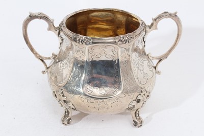 Lot 339 - Victorian silver two handled sugar bowl of cauldron form with engraved faceted panels and scroll border, raised on four scroll feet, (London 1866), maker Robert Harper, all at 15oz, 19cm in diamete...