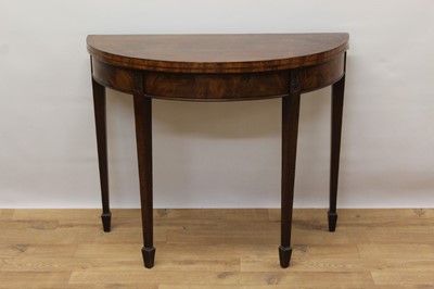 Lot 1427 - George III mahogany demi-lune card table on square taper legs and spade feet