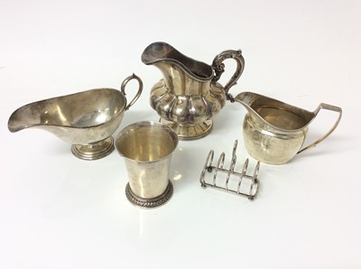 Lot 342 - George V silver sauce boat of helmet form, on circular pedestal foot, (Sheffield 1921), maker Thomas Bradbury & Sons Ltd, together with a silver jugs, a white metal jug, silver beaker and silver...