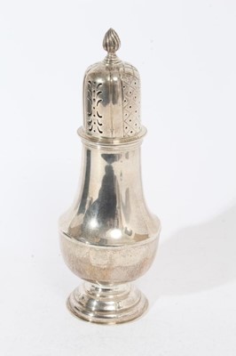 Lot 343 - Edwardian silver sugar caster of baluster form with pierced slip in cover, on circular pedestal foot, (Sheffield 1908), maker William Hutton & Sons Ltd, at approximately 11oz, 23.5cm in overall hei...