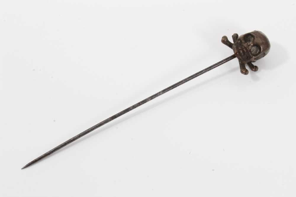 Lot 78 - Victorian momento mori stick pin with brass skull and cross bones on a steel pin