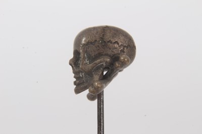 Lot 455 - Victorian momento mori stick pin with brass skull and cross bones on a steel pin