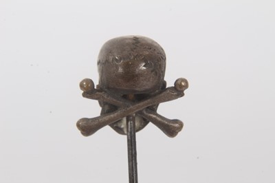 Lot 455 - Victorian momento mori stick pin with brass skull and cross bones on a steel pin