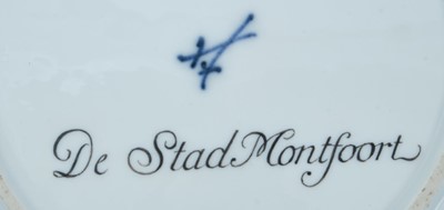 Lot 173 - A Meissen plate from the Stadhouder William V service, circa 1772-74, blue crossed swords and dot mark, the centre painted with a view of 'De Stad Montfoort', titled on the reverse in black script,...