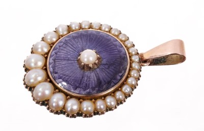 Lot 475 - Victorian gold enamel and pearl pendant/brooch locket, the circular purple guilloché enamel plaque with a graduated crescent shape pearl border with glazed locket compartment to the reverse. Approx...