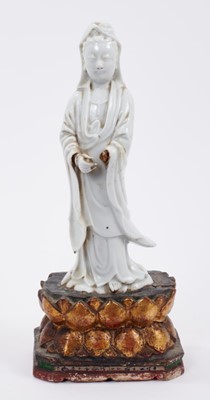 Lot 190 - Chinese blanc de chine figure of Guanyin, Qing period, mounted on a gilt wood double lotus base, 27.5cm high