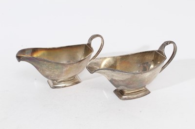 Lot 347 - Pair of George V Art Deco silver sauce boats of navette form, raised on shaped rectangular bases, (Birmingham 1930), maker Elkington & Co, all at approximately 12oz, each 16.2cm in length