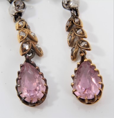 Lot 491 - Pair of Edwardian pink topaz and diamond pendant earrings, each with a pear cut pink topaz suspended from rose cut diamond foliage and collet set old cut diamond, with 9ct white gold screw fittings...