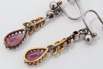 Lot 491 - Pair of Edwardian pink topaz and diamond pendant earrings, each with a pear cut pink topaz suspended from rose cut diamond foliage and collet set old cut diamond, with 9ct white gold screw fittings...