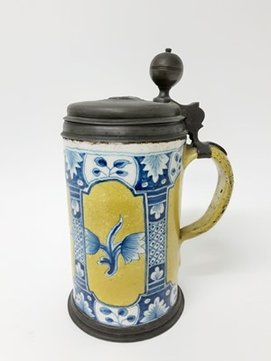 Lot 197 - 18th century dated German pewter-mounted faience tankard, painted with flowers on a yellow ground, the lid engraved '1747' with the initials 'AK', 26cm high