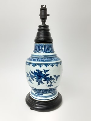 Lot 202 - Chinese Qing period blue and white porcelain vase, painted with pomegranates, cut down and converted to a lamp with a good quality turned wood top, 28.5cm high