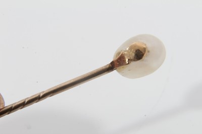 Lot 495 - Antique natural pearl stick pin with an oval natural pearl (saltwater) measuring approximately 5.8mm x 6mm x 8.5mm. Accompanied by a Pearl Report by The Gem & Pearl Laboratory dated 2014.