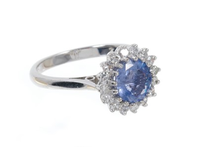 Lot 496 - Sapphire and diamond cluster ring with a round mixed cut cornflower blue sapphire estimated to weigh approximately 1.6cts surrounded by a border of 16 single cut diamonds in claw setting on 18ct wh...