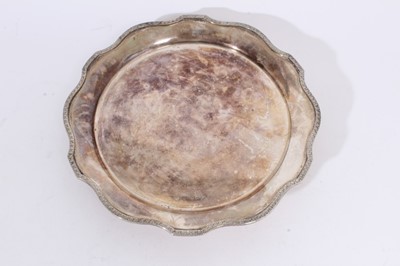 Lot 360 - George V silver salver with pie crust edge and floral border, raised on three paw feet (London 1936), maker Alexander Clark & Co Ltd, all at approximately 22oz, 25.5cm in diameter