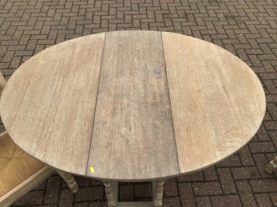 Lot 149 - Limed oak drop leaf table together with a set...