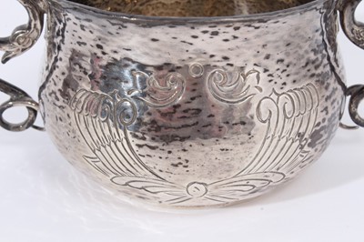Lot 362 - George V silver porringer of baluster form with chased decoration on planished ground, with two handles modelled as coiled serpents, (London 1914), maker D & J Wellby Ltd, all at 11oz, 16cm in widt...