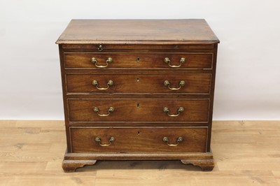 Lot 1445 - George II mahogany dressing chest of small size, with crossbanded top over brushing slide and four graduated drawers, each with brass swan neck handles on ogee bracket feet, 82cm wide x 48cm deep x...