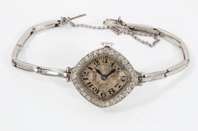 Lot 559 - Art Deco ladies diamond cocktail wristwatch by Tempor Watch Co, with lozenge shape dial and diamond set bezel in platinum case on later white metal bracelet, in an Art Deco 'piano shape' box, retai...