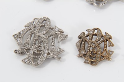 Lot 513 - Set of five Edwardian diamond monograms, each openwork plaque set with single cut diamonds in millegrain setting, probably originally applied to a silk band, together with a matching clasp. Largest...